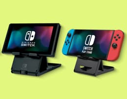 The Nintendo Switch OLED stand next to the smaller stand on the regular Switch.